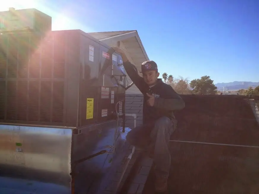 HVAC technician performing Heat Pump Repair on a rooftop unit in Washougal